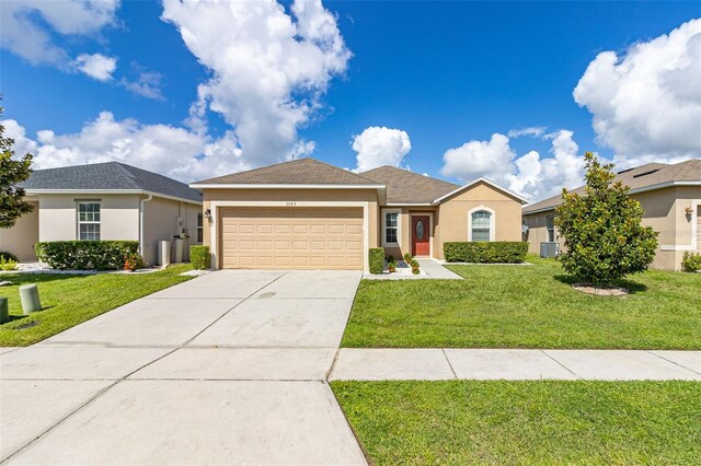 single story home featuring cooling unit, a garage, and a front lawn