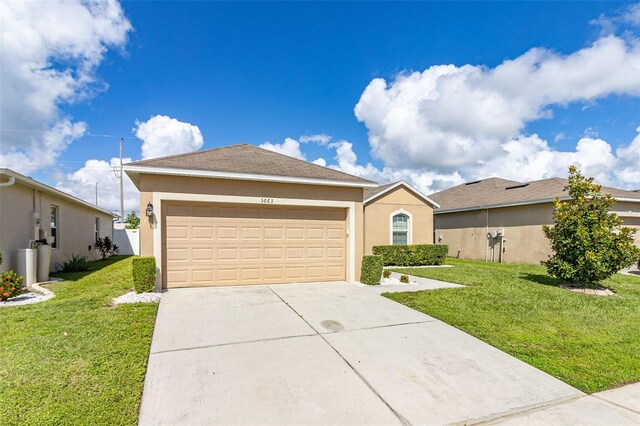 ranch-style house with a garage and a front lawn