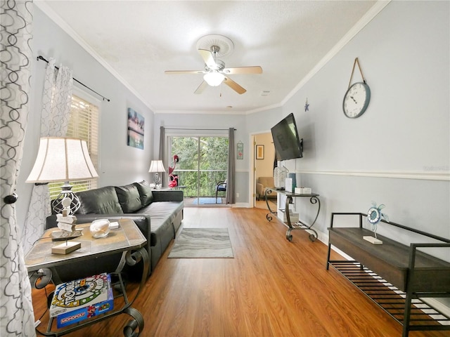 living room featuring crown molding, ceiling fan, and light hardwood / wood-style floors