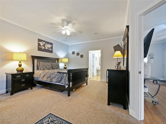 carpeted bedroom featuring ceiling fan, ornamental molding, and ensuite bathroom