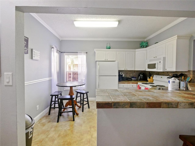 kitchen featuring white cabinetry, white appliances, tile countertops, backsplash, and kitchen peninsula