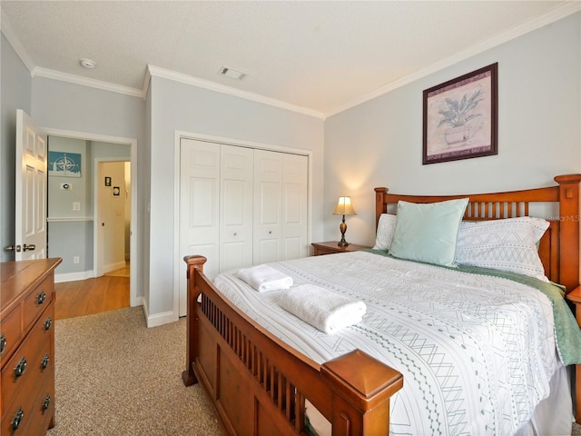 bedroom with ornamental molding, a closet, and light wood-type flooring