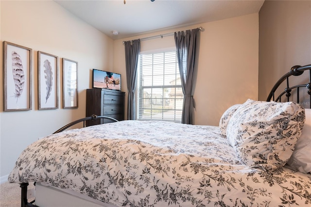 bedroom featuring lofted ceiling and carpet floors