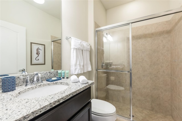 bathroom with vanity, toilet, and walk in shower