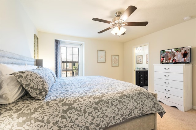 carpeted bedroom featuring ensuite bathroom and ceiling fan