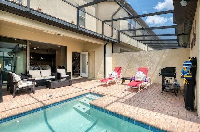 view of pool with an outdoor hangout area, a lanai, a patio area, and a jacuzzi