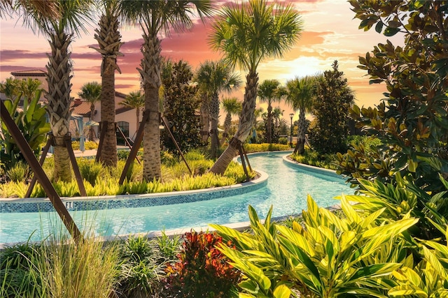 view of pool at dusk