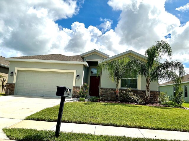 view of front of home with a front lawn and a garage