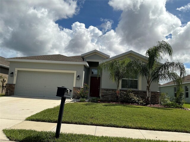 view of front of house with a front lawn and a garage