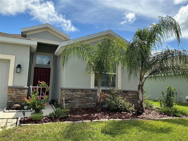 entrance to property featuring a yard