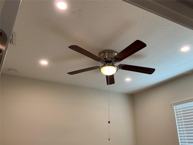 interior details featuring a textured ceiling and recessed lighting