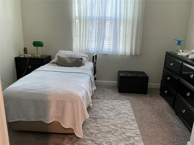 bedroom featuring carpet floors and baseboards