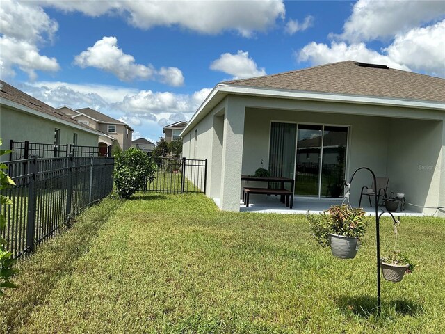4183 Cortland Dr, Davenport, FL 33837 - rear view of property featuring a lawn, a patio area, stucco siding, and fence