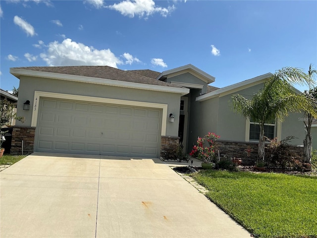 4183 Cortland Dr, Davenport, FL 33837 - view of front of home featuring a garage, driveway, stone siding, and stucco siding