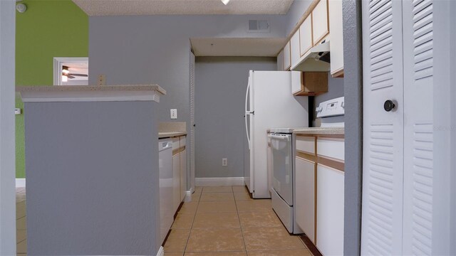 kitchen with visible vents, under cabinet range hood, white cabinetry, white appliances, and light tile patterned floors