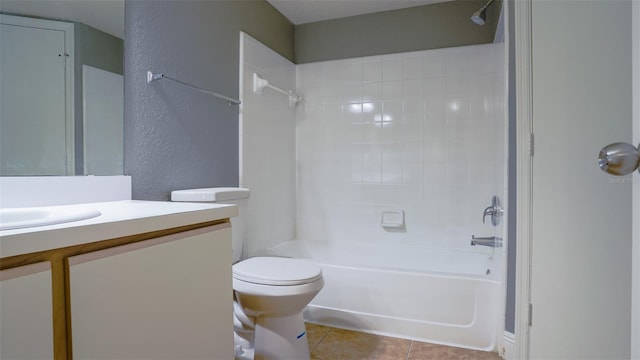 full bath with tile patterned floors, toilet, shower / tub combination, vanity, and a textured wall