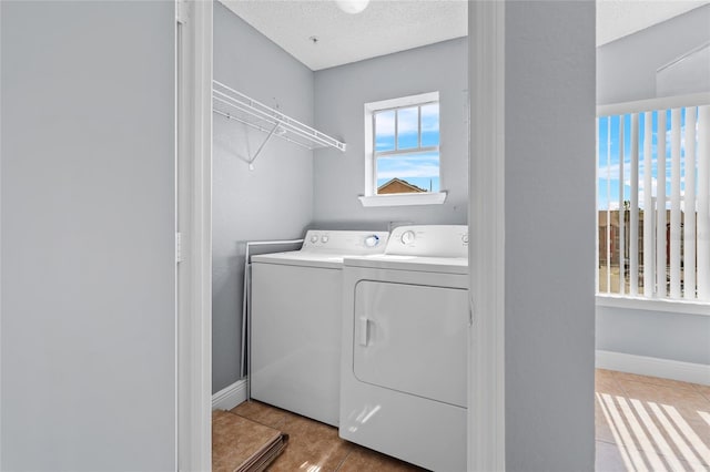 2217 Grand Cayman Ct Unit 1233, Kissimmee, FL 34741 - washroom featuring washing machine and clothes dryer and a textured ceiling