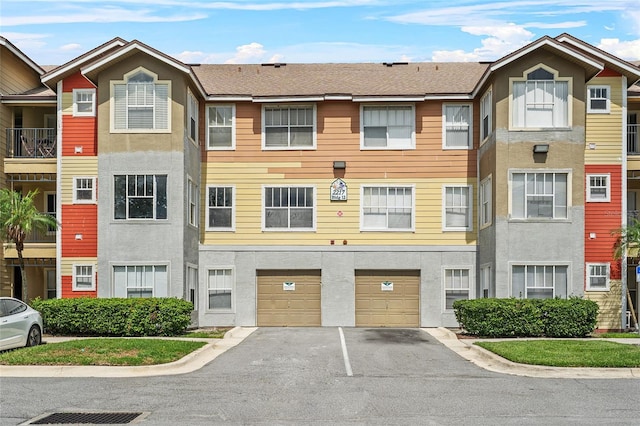 2217 Grand Cayman Ct Unit 1233, Kissimmee, FL 34741 - townhome / multi-family property featuring driveway, an attached garage, and stucco siding