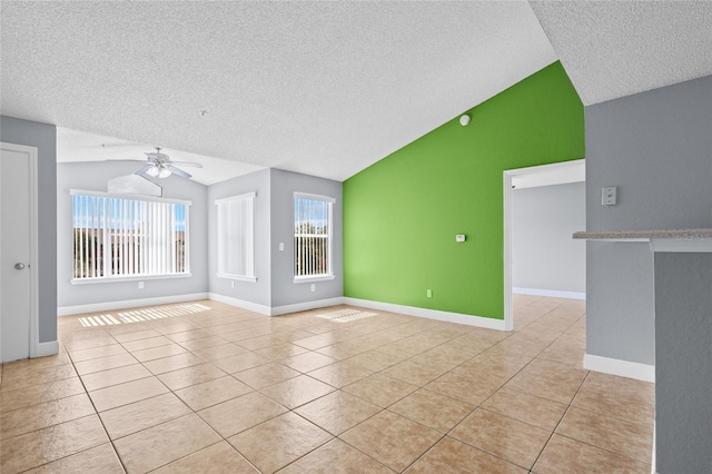 2217 Grand Cayman Ct Unit 1233, Kissimmee, FL 34741 - unfurnished living room featuring vaulted ceiling, a textured ceiling, light tile patterned floors, a ceiling fan, and an accent wall