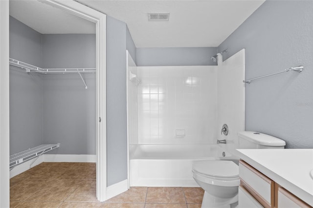 2217 Grand Cayman Ct Unit 1233, Kissimmee, FL 34741 - bathroom featuring shower / bath combination, vanity, tile patterned flooring, and a walk in closet