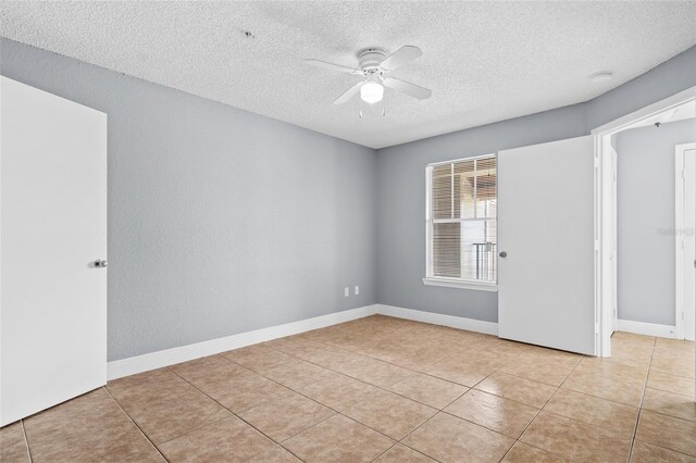 2217 Grand Cayman Ct Unit 1233, Kissimmee, FL 34741 - spare room with a textured ceiling, a ceiling fan, and light tile patterned flooring