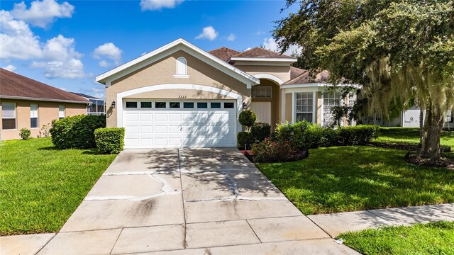 view of front of house with a garage and a front yard