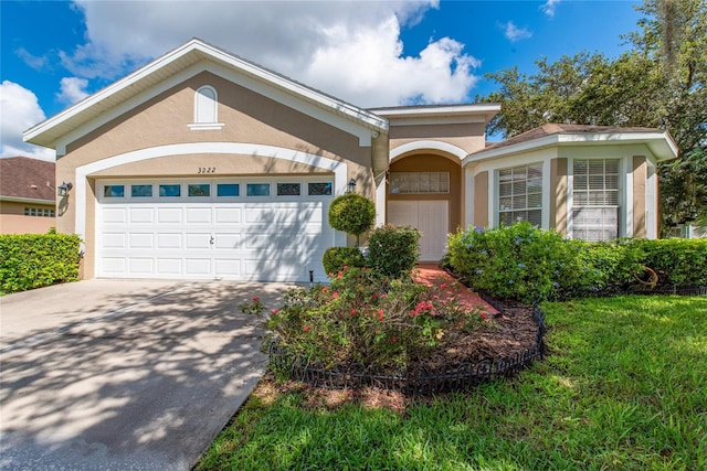 ranch-style home with a front lawn and a garage