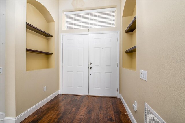 foyer entrance featuring dark hardwood / wood-style floors