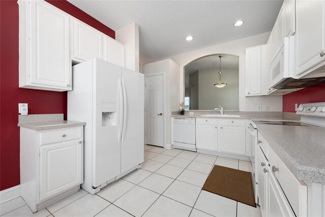 kitchen with white appliances, white cabinetry, sink, light tile patterned flooring, and pendant lighting