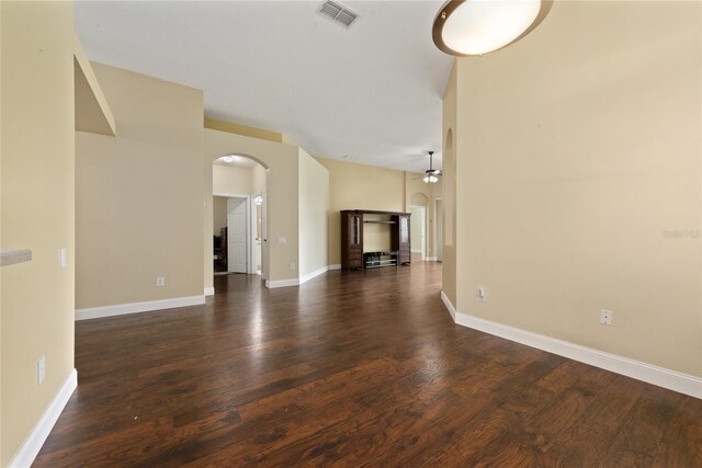 unfurnished living room with dark wood-type flooring and ceiling fan