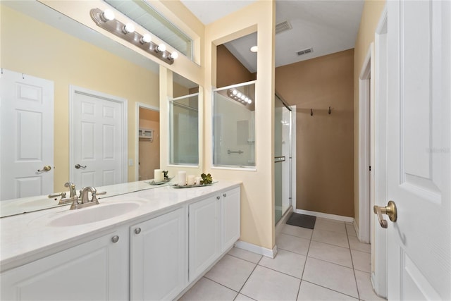 bathroom with a stall shower, visible vents, baseboards, tile patterned flooring, and vanity