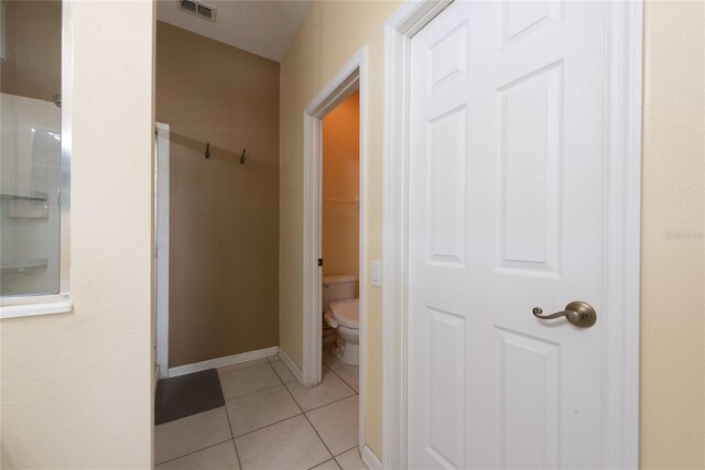 hall with light tile patterned floors