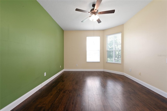 spare room with ceiling fan, dark hardwood / wood-style flooring, and a textured ceiling