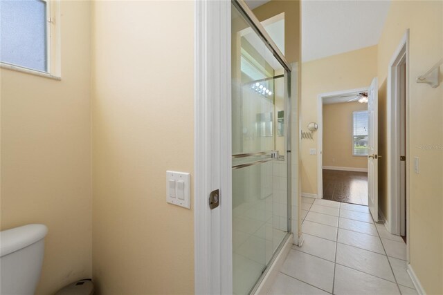 bathroom with an enclosed shower, ceiling fan, toilet, and plenty of natural light