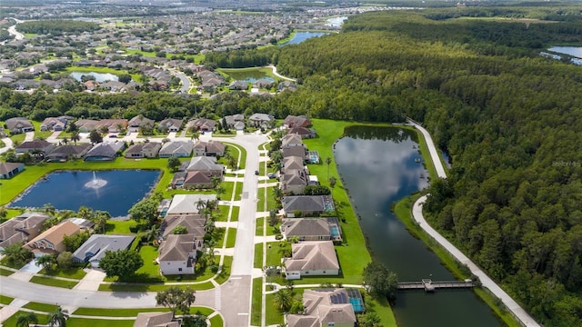 birds eye view of property with a residential view, a water view, and a wooded view