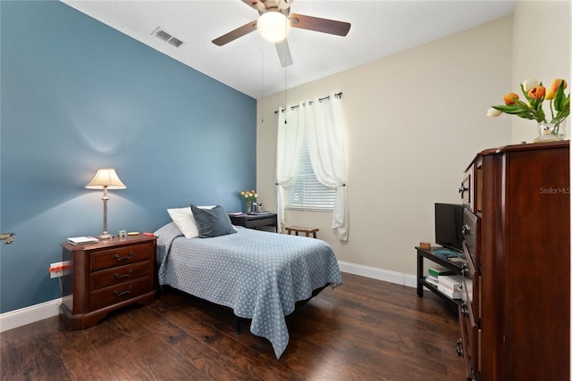 bedroom featuring ceiling fan, dark wood finished floors, visible vents, and baseboards