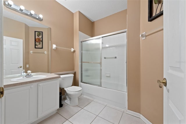 bathroom featuring a textured ceiling, tile patterned flooring, toilet, vanity, and combined bath / shower with glass door