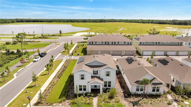 birds eye view of property with a water view and a residential view