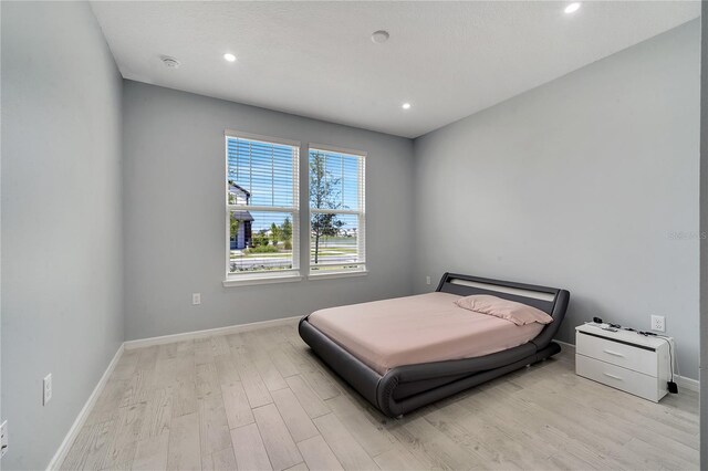 bedroom with light hardwood / wood-style floors