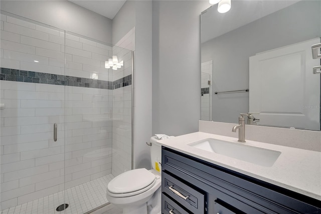 bathroom featuring toilet, a stall shower, and vanity