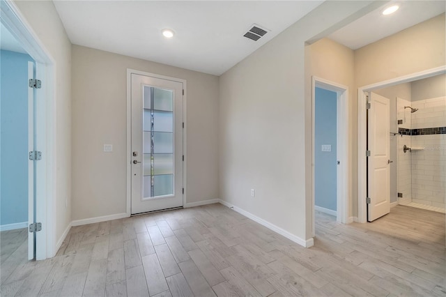 interior space featuring baseboards, recessed lighting, visible vents, and light wood-style floors