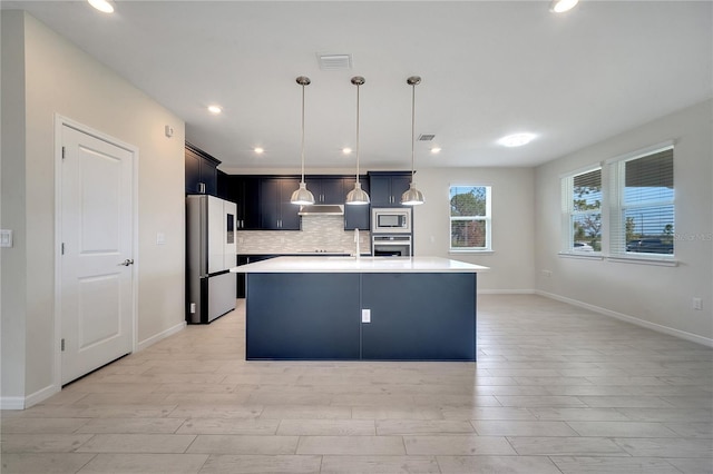 kitchen featuring stainless steel appliances, visible vents, light countertops, light wood finished floors, and tasteful backsplash