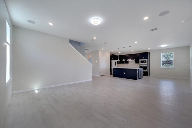 unfurnished living room featuring hardwood / wood-style floors