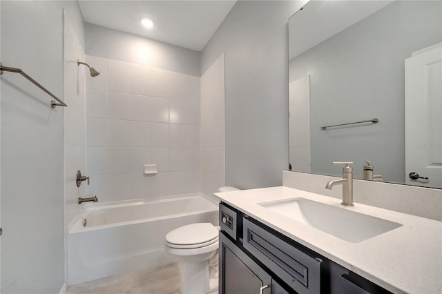 full bathroom featuring tiled shower / bath, vanity, toilet, and hardwood / wood-style flooring