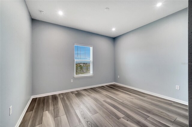 unfurnished room with light wood-type flooring