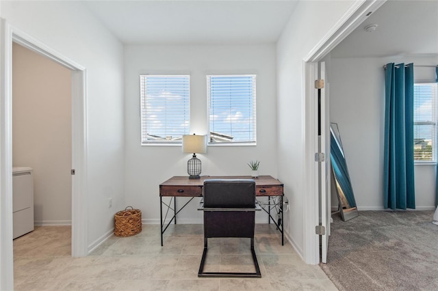 carpeted office featuring washer / dryer