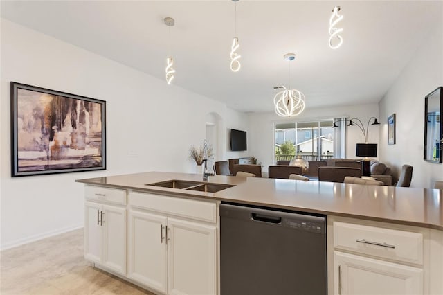 kitchen featuring dishwasher, decorative light fixtures, sink, and white cabinets