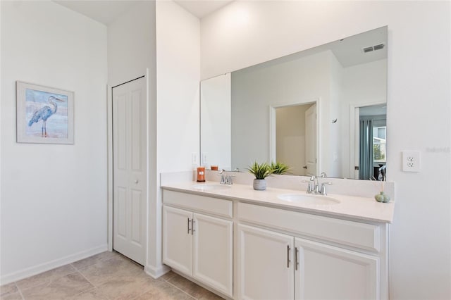 bathroom with tile patterned flooring and vanity