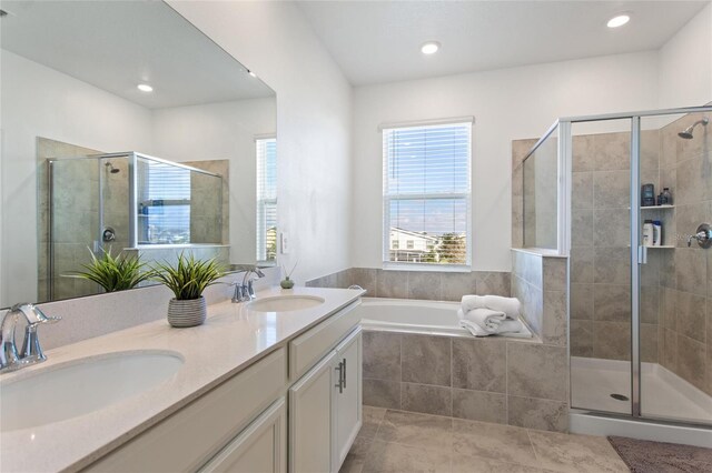 bathroom featuring vanity, tile patterned floors, and shower with separate bathtub