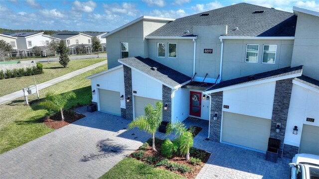 view of front of home with a garage and a front lawn